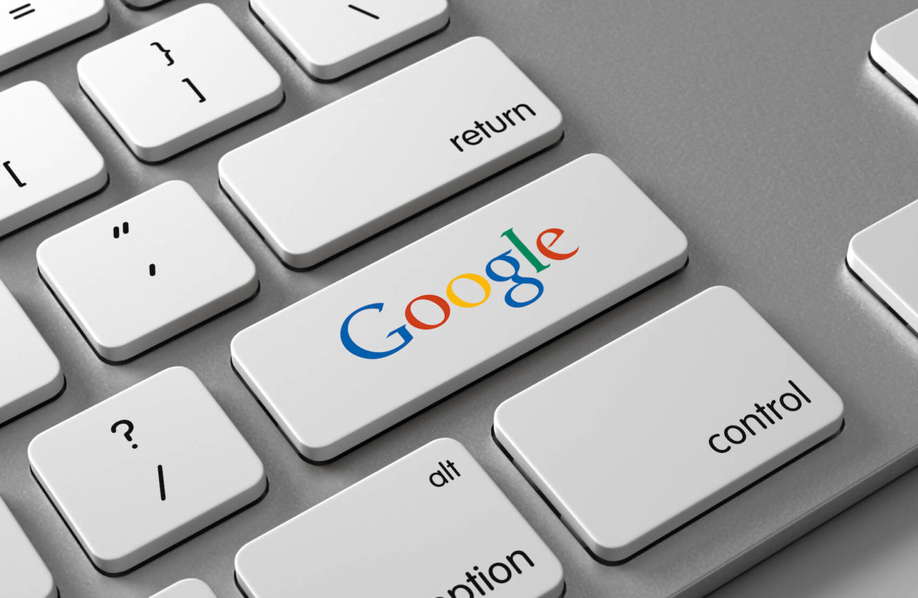 A computer keyboard with a Google button