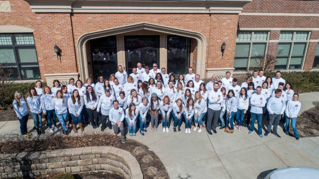 drone shot of KTA team members in front of building